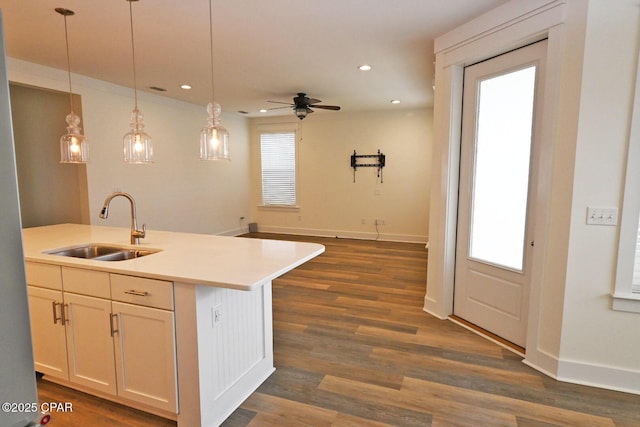 3116 Veranda Ave, Panama City, FL 32405 - kitchen featuring a sink, ceiling fan, light countertops, decorative light fixtures, and dark wood-type flooring