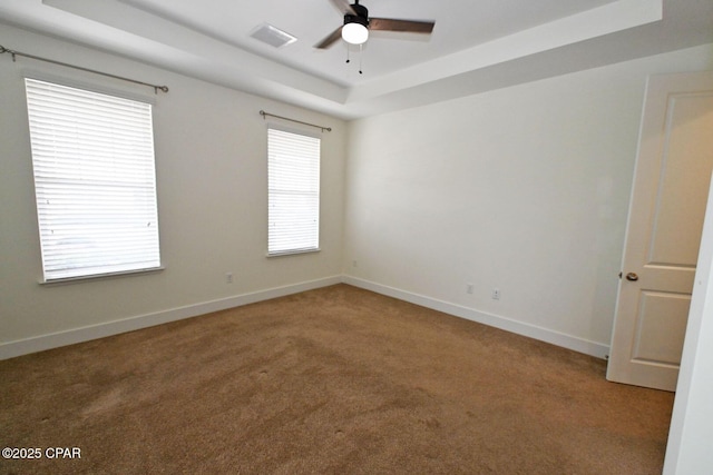 3116 Veranda Ave, Panama City, FL 32405 - unfurnished room featuring light carpet, visible vents, baseboards, ceiling fan, and a raised ceiling