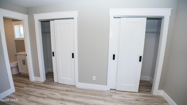 6401 Chipewa St, Panama City, FL 32404 - unfurnished bedroom featuring multiple closets, light wood finished floors, and baseboards