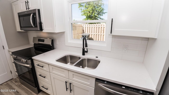 6401 Chipewa St, Panama City, FL 32404 - kitchen featuring a sink, tasteful backsplash, white cabinetry, and stainless steel appliances