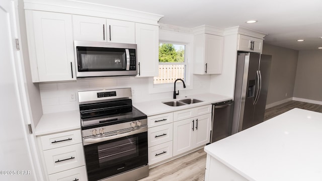 6401 Chipewa St, Panama City, FL 32404 - kitchen with a sink, light countertops, appliances with stainless steel finishes, light wood finished floors, and backsplash