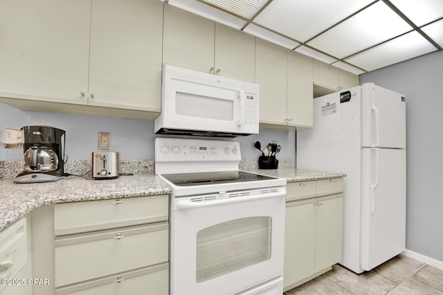 520 Richard Jackson Blvd Unit 2005, Panama City Beach, FL 32407 - kitchen with cream cabinetry, white appliances, and light stone countertops