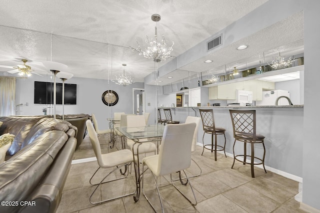520 Richard Jackson Blvd Unit 2005, Panama City Beach, FL 32407 - dining room featuring a textured ceiling, visible vents, baseboards, and ceiling fan with notable chandelier