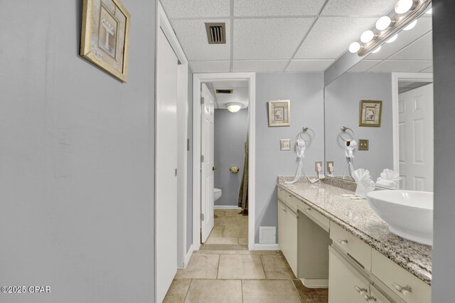 520 Richard Jackson Blvd Unit 2005, Panama City Beach, FL 32407 - bathroom featuring visible vents, tile patterned flooring, double vanity, a paneled ceiling, and a sink