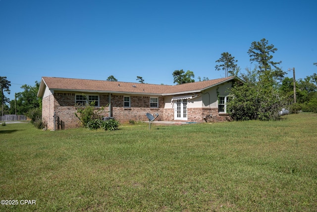 4873 Donna Dr, Marianna, FL 32446 - back of house featuring a yard, french doors, and brick siding