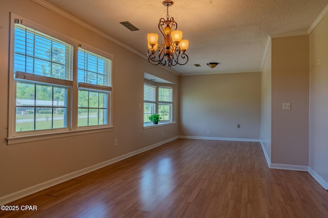 4873 Donna Dr, Marianna, FL 32446 - spare room with an inviting chandelier, a textured ceiling, and wood finished floors