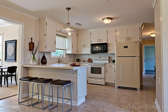 4873 Donna Dr, Marianna, FL 32446 - kitchen featuring a peninsula, visible vents, white cabinets, and white appliances