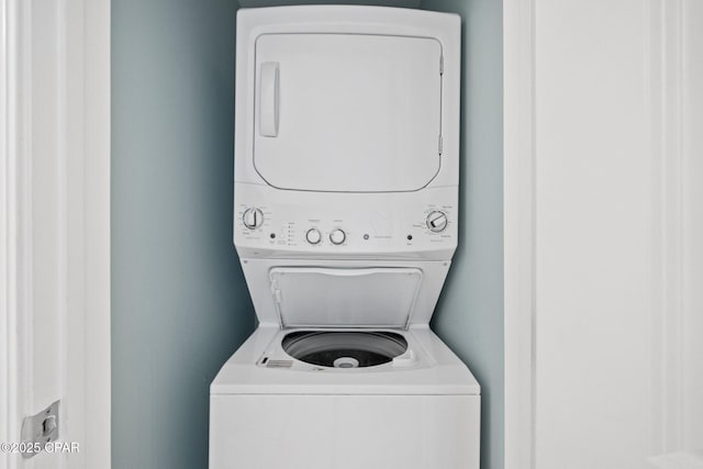 laundry room with stacked washer / drying machine and laundry area
