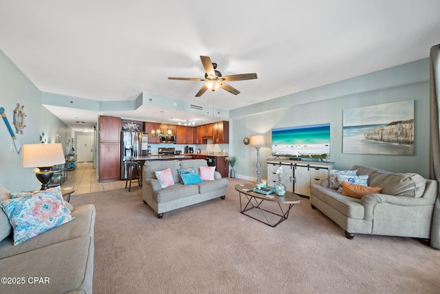 living area featuring light colored carpet and ceiling fan