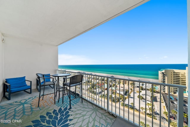balcony with a view of the beach and a water view