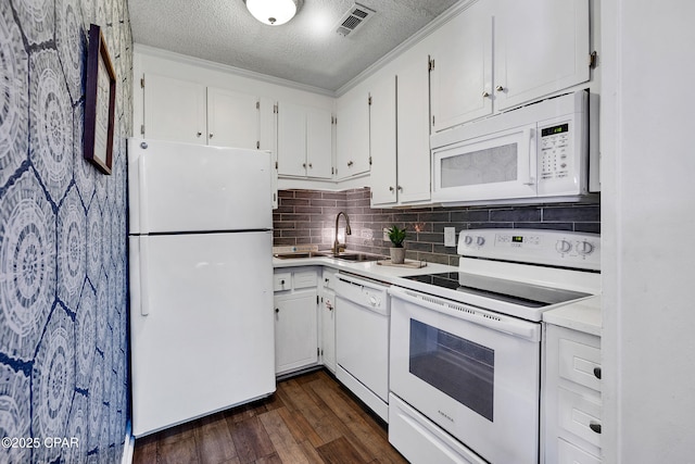 17462 Front Beach Rd Unit 33D, Panama City Beach, FL 32413 - kitchen with dark wood finished floors, light countertops, visible vents, white appliances, and a textured ceiling