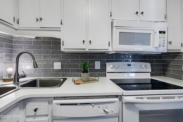 17462 Front Beach Rd Unit 33D, Panama City Beach, FL 32413 - kitchen with a sink, decorative backsplash, white appliances, white cabinets, and light stone countertops