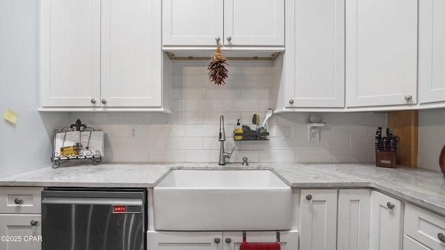kitchen featuring a sink, dishwasher, and white cabinets