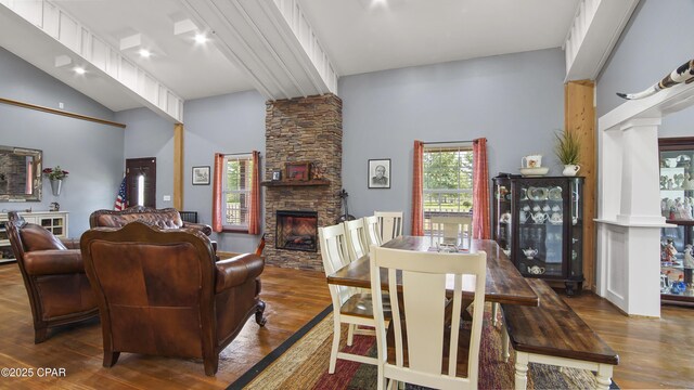 10583 State Road 20, Clarksville, FL 32430 - dining room featuring high vaulted ceiling, decorative columns, a stone fireplace, and wood finished floors