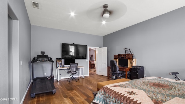 bedroom featuring wood-type flooring, a ceiling fan, baseboards, and visible vents