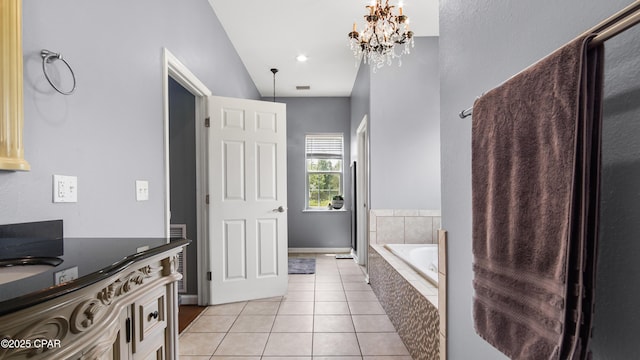 bathroom featuring tile patterned flooring, an inviting chandelier, and a bath