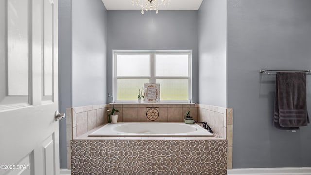 full bathroom featuring a bath and a chandelier
