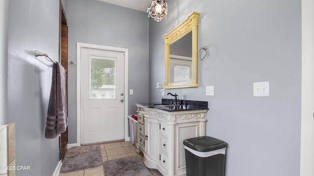 bathroom with tile patterned flooring, baseboards, and vanity