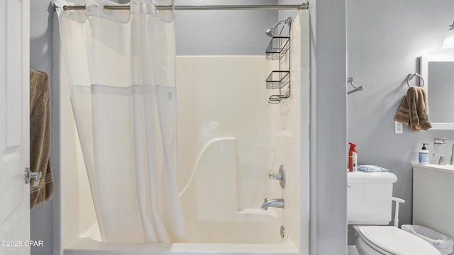 bathroom with shower / bath combo and toilet
