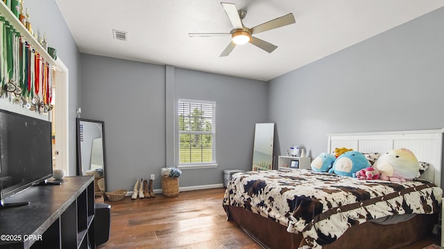 bedroom featuring wood-type flooring, baseboards, visible vents, and ceiling fan