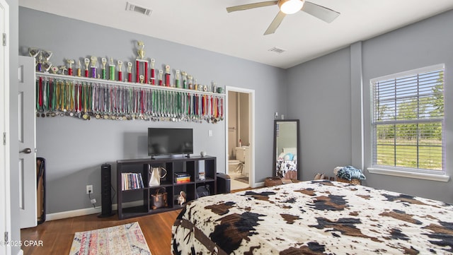 bedroom featuring multiple windows, wood finished floors, and visible vents