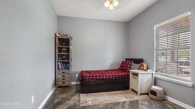 bedroom featuring baseboards, ceiling fan, and wood finished floors