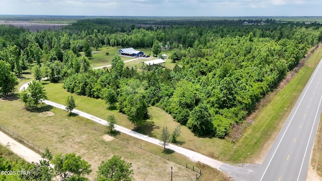 drone / aerial view featuring a forest view