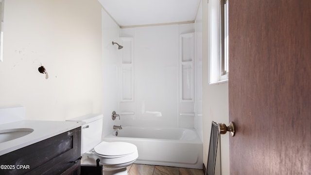 full bath featuring toilet, vanity, and tub / shower combination