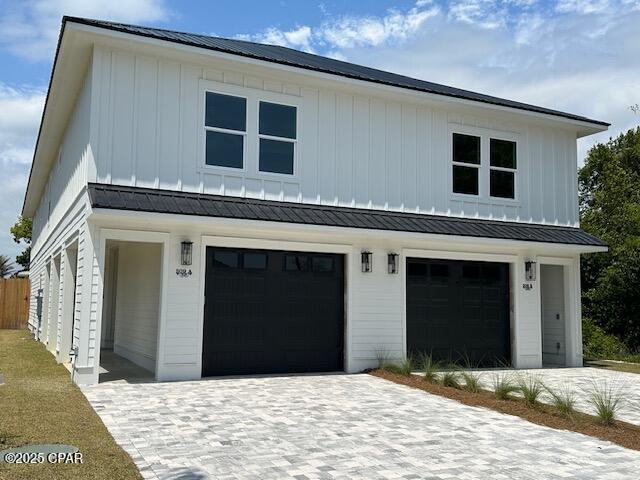 309 Paridiso Pl Unit A, Panama City Beach, FL 32413 - modern farmhouse with board and batten siding, an attached garage, decorative driveway, and metal roof