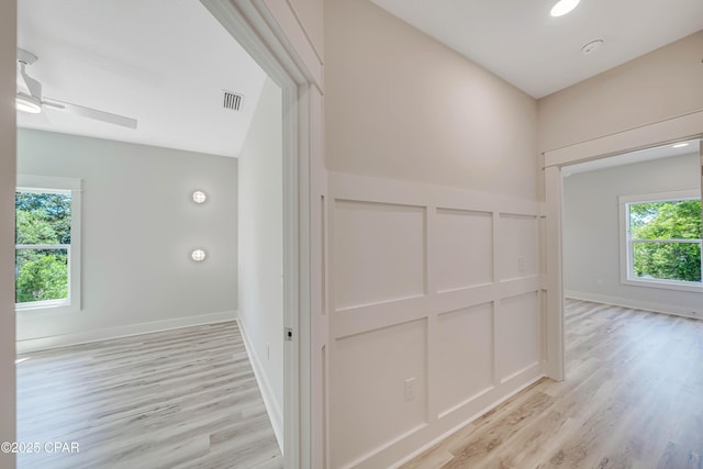 309 Paridiso Pl Unit A, Panama City Beach, FL 32413 - corridor with plenty of natural light and light wood-style flooring