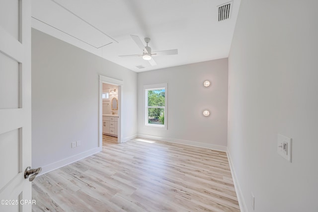 309 Paridiso Pl Unit A, Panama City Beach, FL 32413 - unfurnished bedroom featuring attic access, light wood-type flooring, baseboards, a ceiling fan, and ensuite bathroom