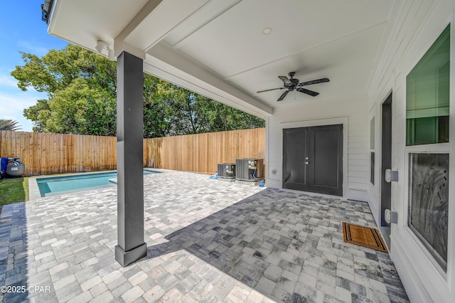 309 Paridiso Pl Unit A, Panama City Beach, FL 32413 - fenced backyard with a patio area, ceiling fan, and central AC unit