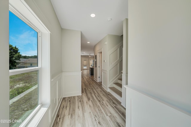 309 Paridiso Pl Unit A, Panama City Beach, FL 32413 - hall with light wood-style flooring, healthy amount of natural light, recessed lighting, wainscoting, and a decorative wall