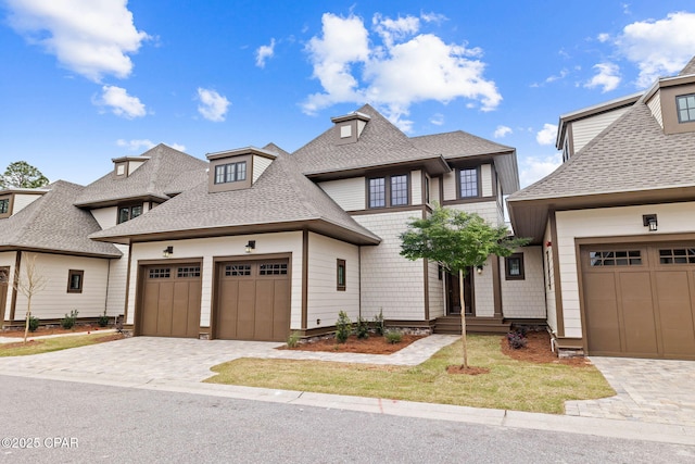 1502 Match Point Ln Unit 402, Panama City Beach, FL 32413 - view of front of home with a shingled roof, decorative driveway, and a garage