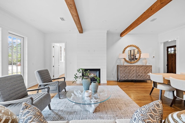 1502 Match Point Ln Unit 402, Panama City Beach, FL 32413 - living area with beamed ceiling, wood finished floors, a large fireplace, and ornamental molding