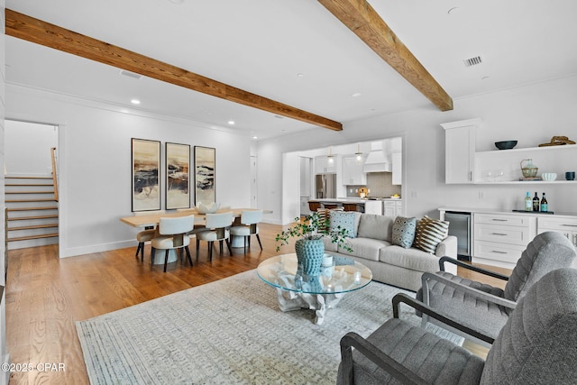1502 Match Point Ln Unit 402, Panama City Beach, FL 32413 - living area with beamed ceiling, bar with sink, light wood-style flooring, stairs, and recessed lighting