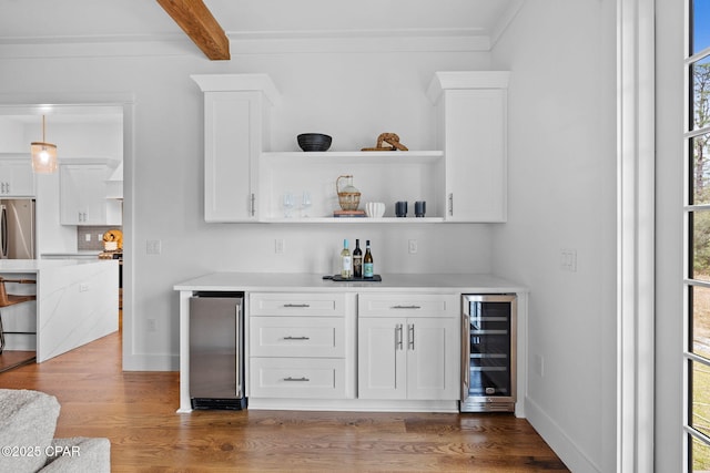 1502 Match Point Ln Unit 402, Panama City Beach, FL 32413 - indoor dry bar featuring beverage cooler, light wood finished floors, backsplash, and beamed ceiling