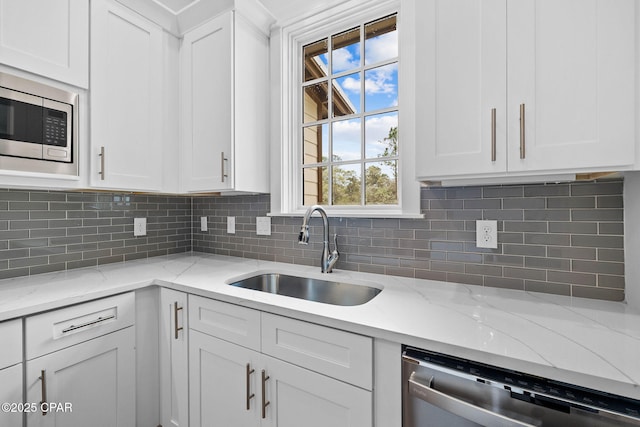 1502 Match Point Ln Unit 402, Panama City Beach, FL 32413 - kitchen with stainless steel appliances, white cabinets, and decorative backsplash