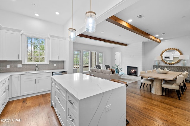 1502 Match Point Ln Unit 402, Panama City Beach, FL 32413 - kitchen featuring healthy amount of natural light, open floor plan, a fireplace, light wood-type flooring, and recessed lighting