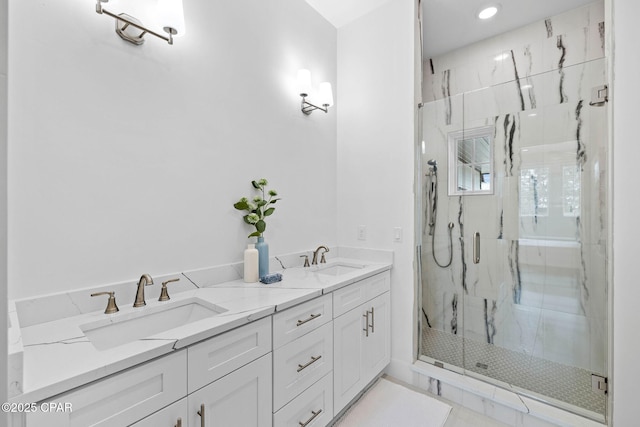 1502 Match Point Ln Unit 402, Panama City Beach, FL 32413 - bathroom with a marble finish shower, double vanity, and recessed lighting