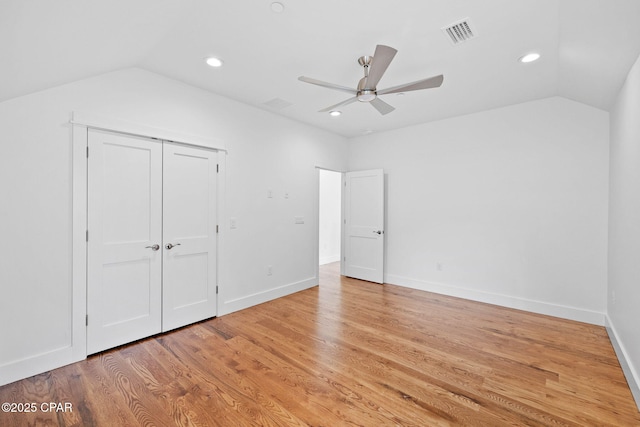 1502 Match Point Ln Unit 402, Panama City Beach, FL 32413 - unfurnished bedroom featuring lofted ceiling, recessed lighting, light wood-type flooring, ceiling fan, and a closet