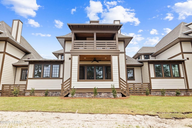 1502 Match Point Ln Unit 402, Panama City Beach, FL 32413 - rear view of property featuring a balcony, ceiling fan, a lawn, and a shingled roof