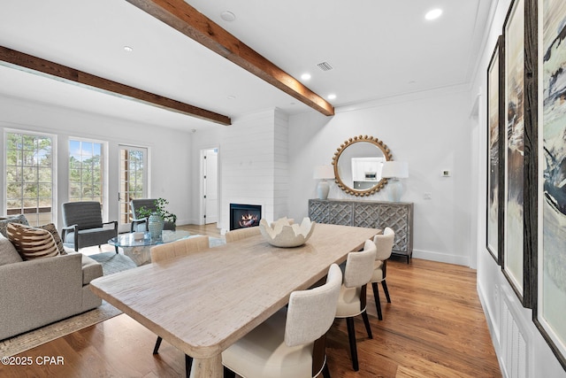 1502 Match Point Ln Unit 402, Panama City Beach, FL 32413 - dining room featuring a large fireplace, beam ceiling, light wood finished floors, and recessed lighting