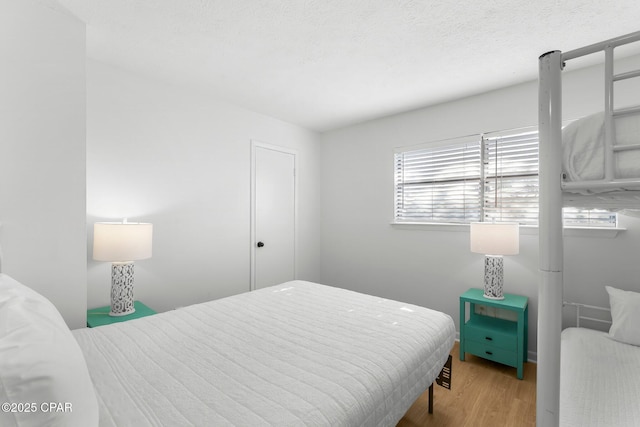 bedroom featuring wood finished floors