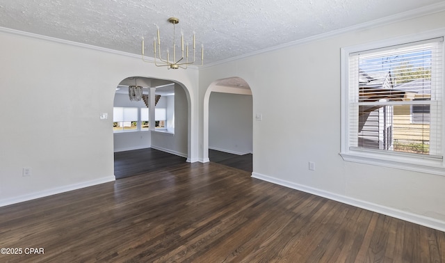 unfurnished dining area with arched walkways, a textured ceiling, wood finished floors, and a wealth of natural light
