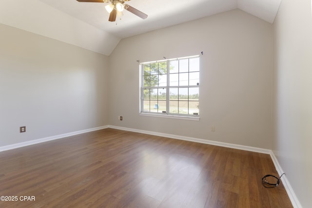 spare room featuring baseboards, ceiling fan, wood finished floors, and lofted ceiling