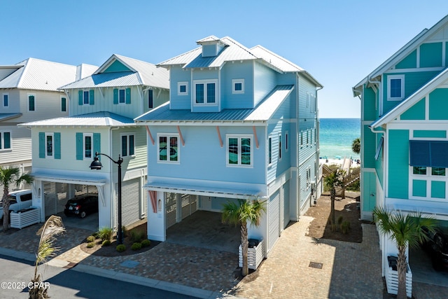 13643 Front Beach Rd, Panama City Beach, FL 32413 - beach home with a carport, driveway, a water view, and a metal roof