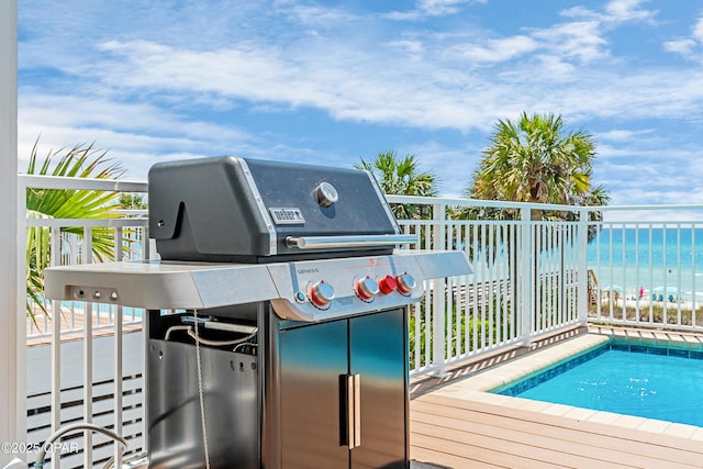 13643 Front Beach Rd, Panama City Beach, FL 32413 - deck with area for grilling, a water view, and an outdoor pool
