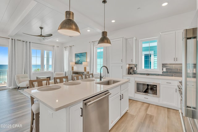 13643 Front Beach Rd, Panama City Beach, FL 32413 - kitchen with stainless steel appliances, healthy amount of natural light, light wood-style floors, beamed ceiling, and recessed lighting