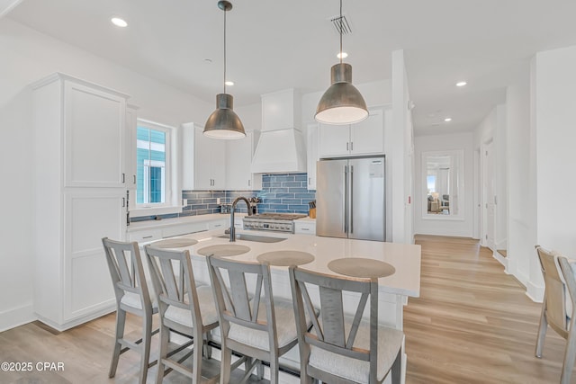 13643 Front Beach Rd, Panama City Beach, FL 32413 - kitchen with high end fridge, light wood-style flooring, tasteful backsplash, light countertops, and recessed lighting